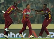 Darren Sammy and Andre Russell congratulate Samuel Badree who took 3 wickets